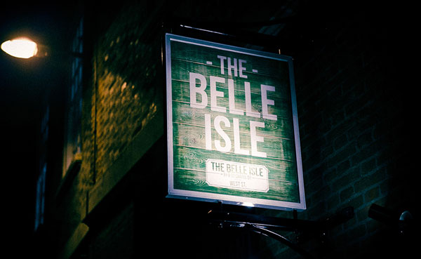 A sign on the side of a building for Belle Isle