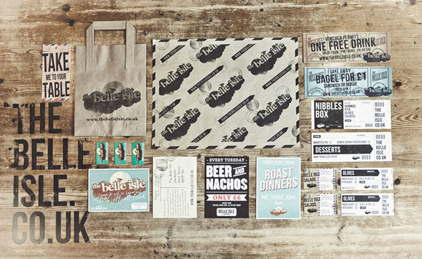 An array of Belle Isle printed material including paper bags and flyers